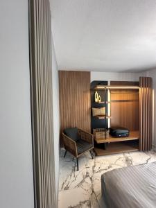 a hotel room with a desk and a chair at Artion Jacuzzi Villa Nikiti in Nikiti +217 photos