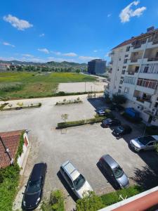 a parking lot with cars parked in front of a building at Asea Apartaments in Golem