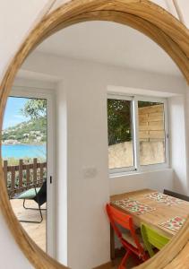 a dining room with a table and a mirror at Seaside Apartment in Conca