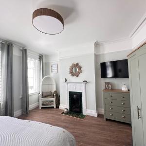 a bedroom with a bed and a fireplace at Exmouth Devon Luxurious Flat OverlookingThe Sea in Exmouth