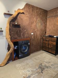 a living room with a tree branch on the wall at Apartment Hosner in Lepena +26 photos