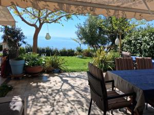 a patio with a table and chairs under an umbrella at Villa Alexander in Xanthi