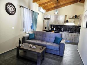 a living room with a blue couch and a table at Elia Paradise Villa with private Pool in Heraklio