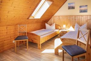 a room with two beds and a window at Familien-Ferienanlage Seefeldt in Freest