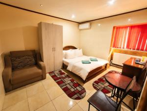 a hotel room with a bed and a chair at Vila Magica in Constanţa