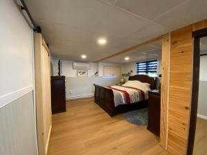 a bedroom with a bed and a wooden floor at 5 bedroom Waterfront house in Tracadie