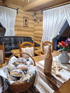a basket of bagels on a table in a dining room at Cabana La Bălănuț din Bucovina in Colacu