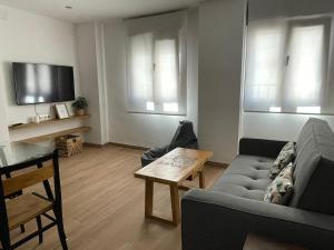 a living room with a couch and a table at Entre Murallas in Doña Mencía