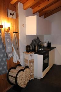 a small kitchen with a stove and a sink at Chalet Alpen Charme in Turtmann