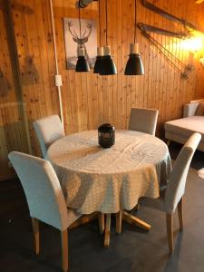 a dining room with a table and four chairs at Chalet Alpen Charme in Turtmann