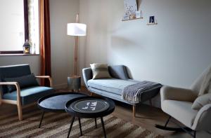 a living room with a couch and chairs and a table at Chambres d'hôtes l'allegra in Saint-Euphrône +25 photos