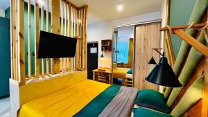 a bedroom with a bed and a television in it at City Vibe Studio in Poznań