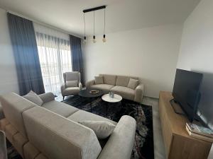 a living room with a couch and a tv at Dali Apartment in Bar