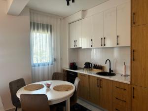 a kitchen with a table and a table and chairs at Dali Apartment in Bar