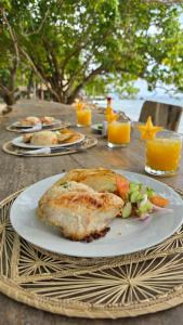 a table with a plate of food on a table at El cielo hotel isla fuerte in Puerto Limón