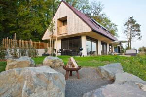 a small house with rocks in front of it at Refugium am Wald in Feldbach