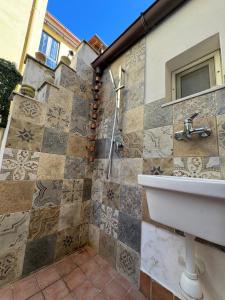 a bathroom with a sink and a tile wall at Dimora Marisa in Termoli