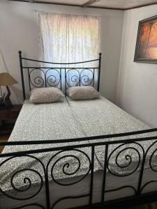 a black bed with two pillows in a bedroom at Paradise on the Vrbas River in Jajce +38 photos
