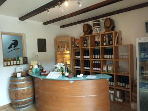 a bar in a wine cellar with a bunch of wine bottles at Weingut Villa Raevenhof in Ayl