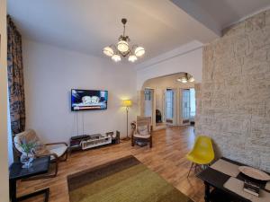 a living room with a stone wall at Villa Boema- with parking for large business groups in Bucharest