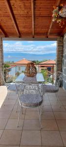 a table and chairs sitting on a patio at Blue Paradise Villa in Karianí