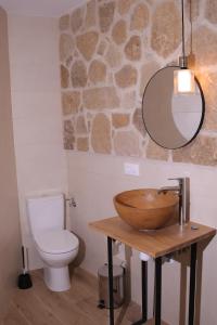 a bathroom with a wooden sink and a toilet at Casa Rural La Canaleja in Berrocalejo +25 photos