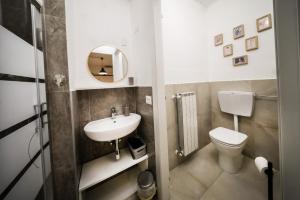a small bathroom with a toilet and a sink at Civico46 in Domodossola +20 photos