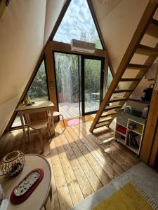 a room with a large window and a wooden floor at Tipi Lodge Glamp Marguerite in Le Boulou