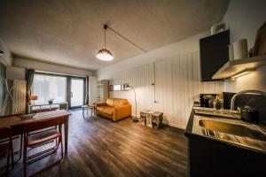 a kitchen and living room with a couch and a table at Civico46 in Domodossola