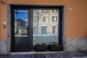 a door with two potted plants in front of a building at Civico46 in Domodossola