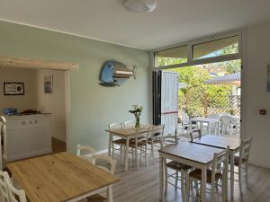 a kitchen and dining room with tables and chairs at Hotel ai Fiori in Grado