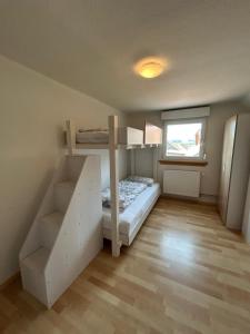 a small room with a bunk bed and a staircase at Molers in Stühlingen