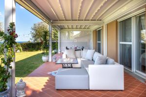 a patio with a couch and a table at Villa Torre Conca Cefalu Coast in Finale