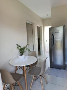 a dining room with a table and a refrigerator at Apartamento de dois quartos centro de Pomerode in Pomerode +10 photos