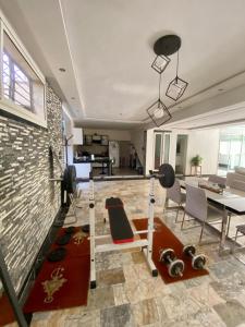 a living room with a couch and a dining room at Loft a cinq minute de la plage in Temara