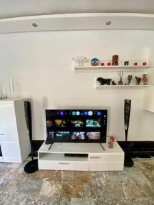 a living room with a flat screen tv on a wall at Loft a cinq minute de la plage in Temara