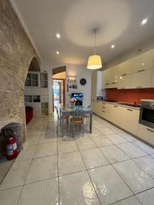 a kitchen with a table and a dining room at Dimora Marisa in Termoli +3 photos