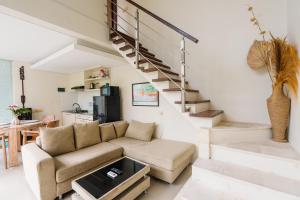 a living room with a couch and stairs at Modern Villa near Seminyak & Canggu, Large Pool in Kerobokan