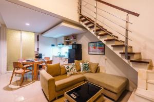 a living room with a couch and a staircase at Modern Villa near Seminyak & Canggu, Large Pool in Kerobokan +38 photos