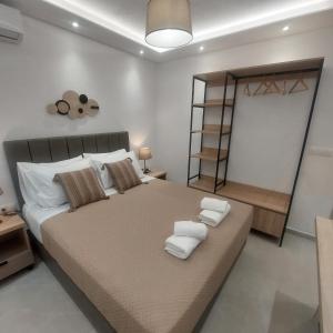 a bedroom with a large bed with towels on it at Malama's apartment in Neos Marmaras