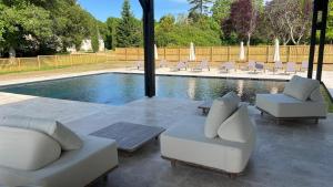 a swimming pool with lounge chairs and a poolurity at Château De Razay in Céré-la-Ronde