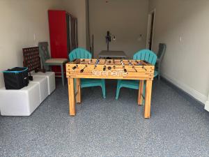 a ping pong table in a room with blue chairs at SEA-Bound STR in Pensacola