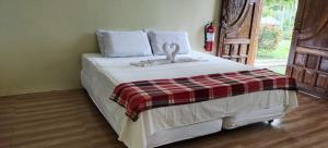 a bedroom with a bed with a stuffed animal on it at Libhu Hill Resort and Sports Complex in Maasin