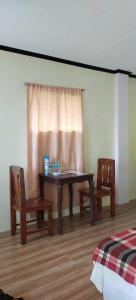 a room with a table and two chairs and a window at Libhu Hill Resort and Sports Complex in Maasin