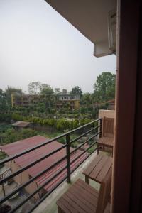 a balcony with benches and a view of a city at Chandrama Hotel and Restaurant in Sauraha