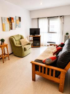 a living room with a couch and a chair at Departamento Mara in Puerto Madryn