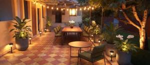 a patio with a table and chairs and plants at Vila Magica in Constanţa