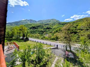 a view of a river and mountains from a house at KOPILOVE in Foča