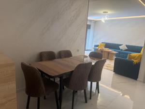 a dining room with a wooden table and chairs at tanger in Oulad Akkou