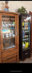 an open refrigerator with food and drinks in it at Pousada Flor De Jambú in São Miguel do Gostoso
